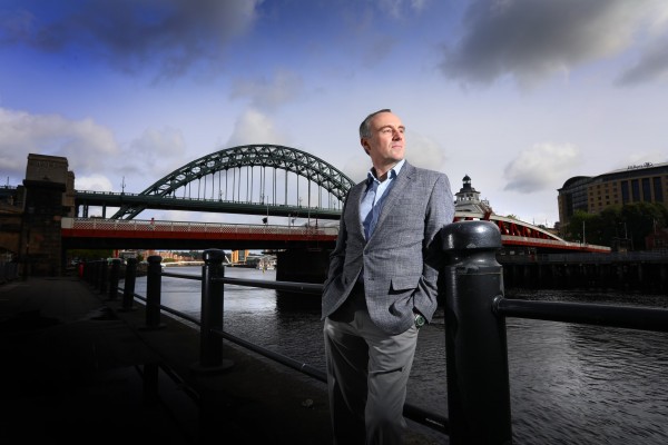 Old Man stood in front of the Tyne Bridge